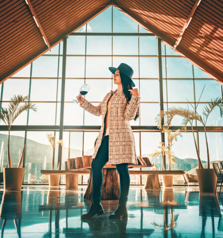 woman standing by window at mexican vineyard - bits lifestyle